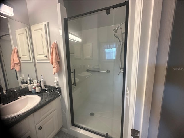 bathroom featuring an enclosed shower and vanity