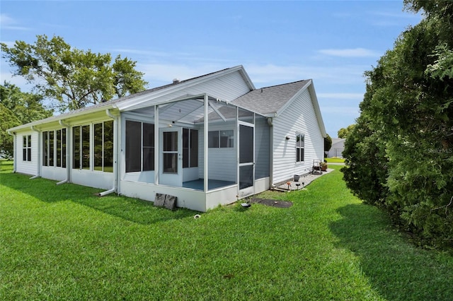 956 Chula Ct, The Villages, FL 32159 - rear view of property with a yard and a sunroom