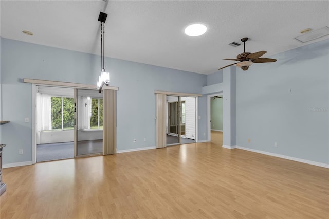 956 Chula Ct, The Villages, FL 32159 - unfurnished living room with light wood-style flooring, baseboards, a ceiling fan, and visible vents
