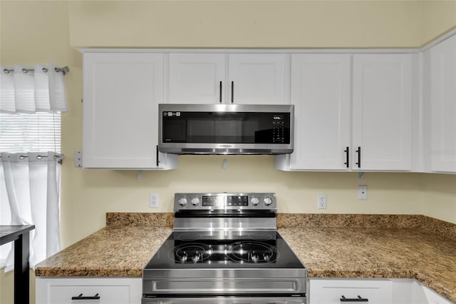 956 Chula Ct, The Villages, FL 32159 - kitchen with light stone countertops, white cabinets, and stainless steel appliances