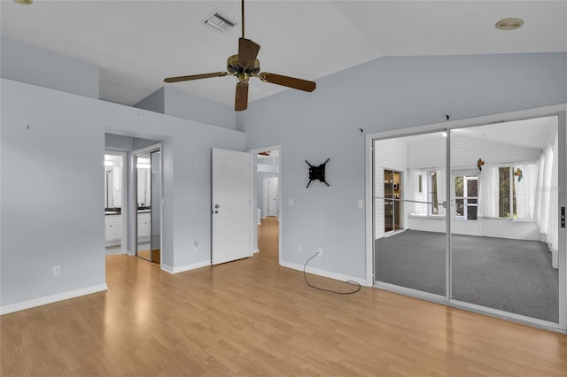 956 Chula Ct, The Villages, FL 32159 - unfurnished bedroom with wood finished floors, ensuite bathroom, vaulted ceiling, and visible vents