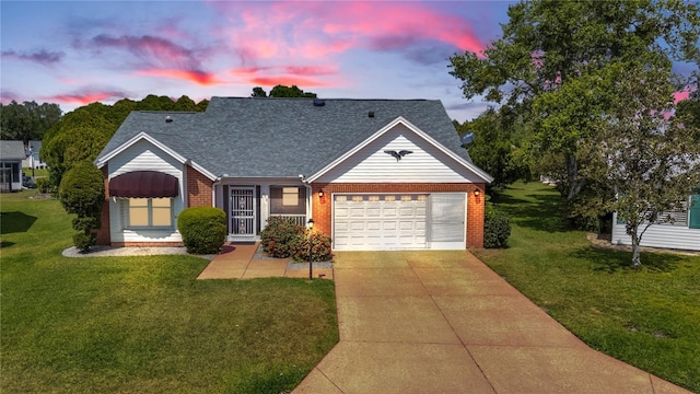 956 Chula Ct, The Villages, FL 32159 - view of front facade featuring a shingled roof, a yard, a garage, brick siding, and driveway
