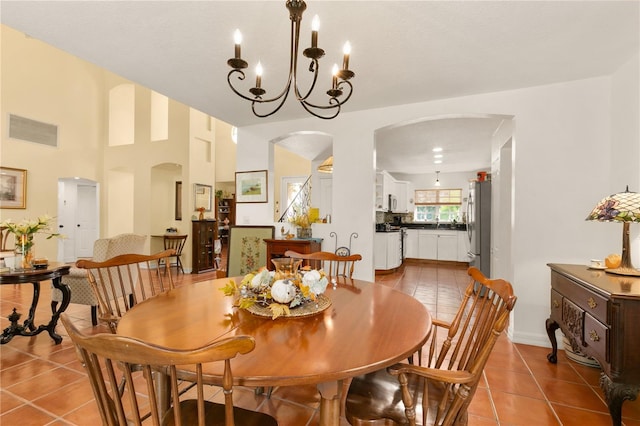 dining area featuring light tile patterned floors and a chandelier