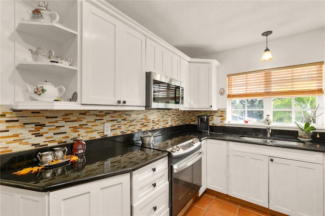 kitchen featuring light tile patterned floors, stainless steel appliances, white cabinetry, and sink