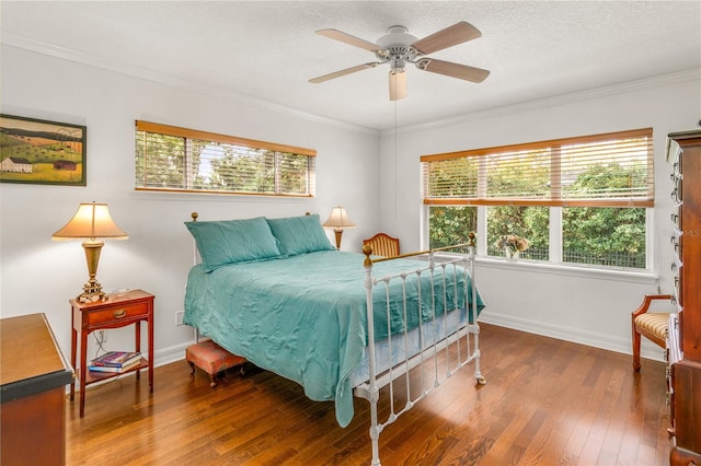 bedroom with hardwood / wood-style floors, ceiling fan, ornamental molding, and a textured ceiling