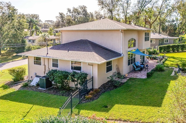 view of home's exterior featuring a lawn, a patio area, and central AC unit