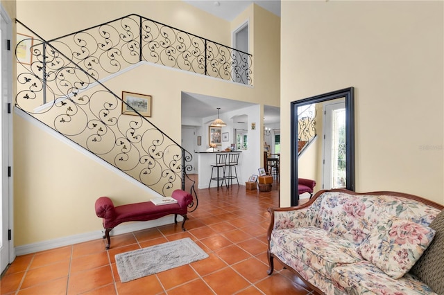 tiled living room featuring a high ceiling