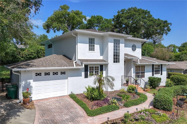 1405 Hilltop Dr, Mount Dora, FL 32757 - traditional home featuring an attached garage, stucco siding, and decorative driveway