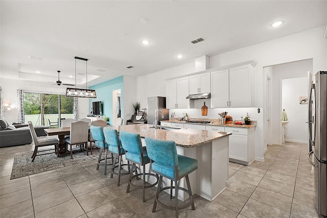 kitchen with white cabinetry, sink, an island with sink, and stainless steel appliances