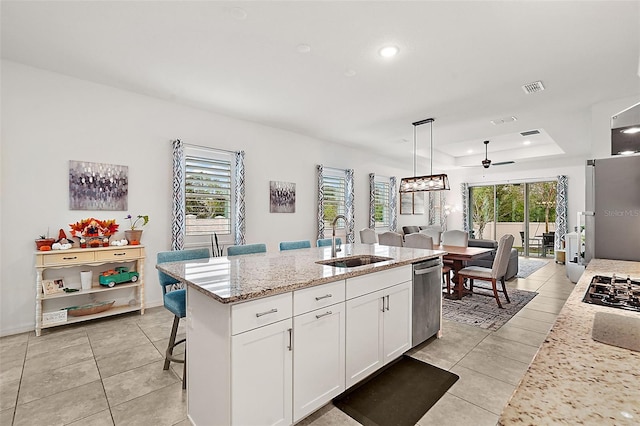 kitchen featuring a wealth of natural light, sink, a center island with sink, and stainless steel appliances