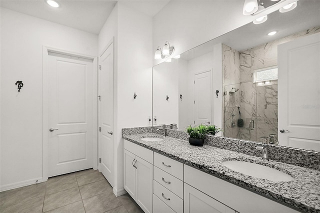 bathroom featuring tile patterned flooring, an enclosed shower, and vanity