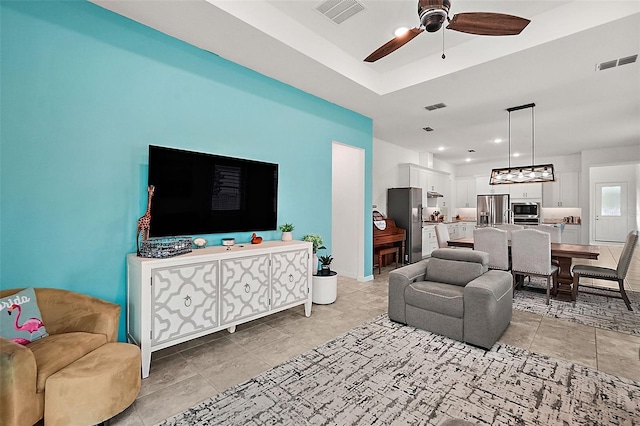 tiled living room featuring ceiling fan