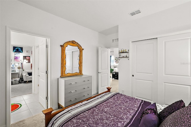 bedroom with light colored carpet and a closet