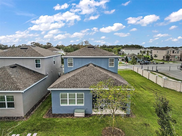 rear view of property featuring a yard