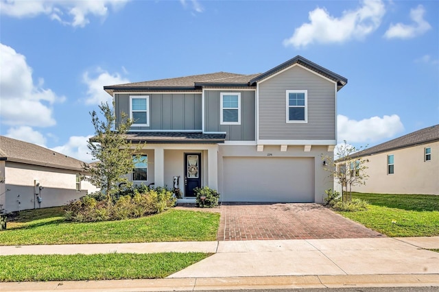 front of property with a front lawn and a garage