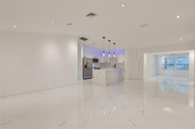 unfurnished living room featuring sink