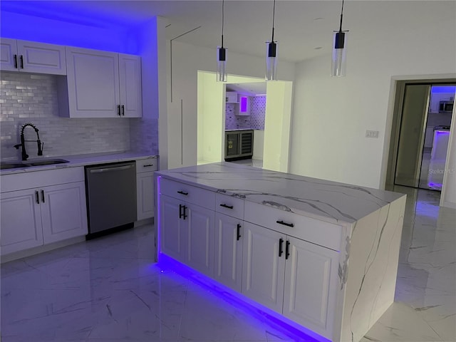 kitchen featuring pendant lighting, a center island, white cabinets, sink, and stainless steel appliances