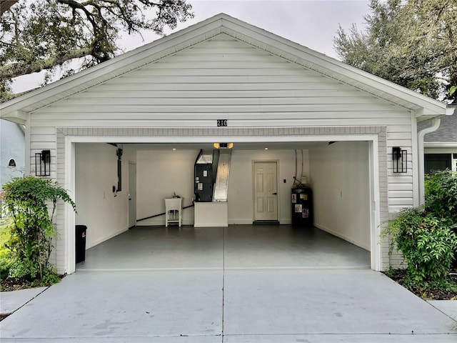 garage featuring heating unit and water heater