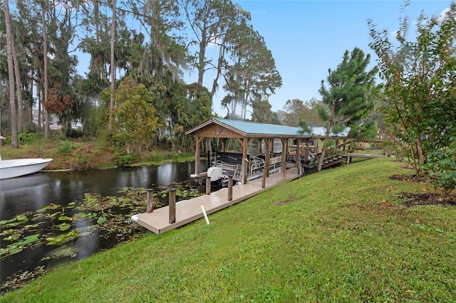 view of dock with a water view and a yard