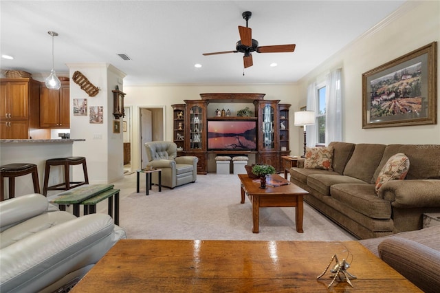 living room featuring light carpet, ceiling fan, and crown molding