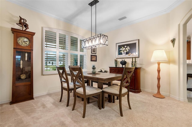 dining room featuring light carpet and crown molding