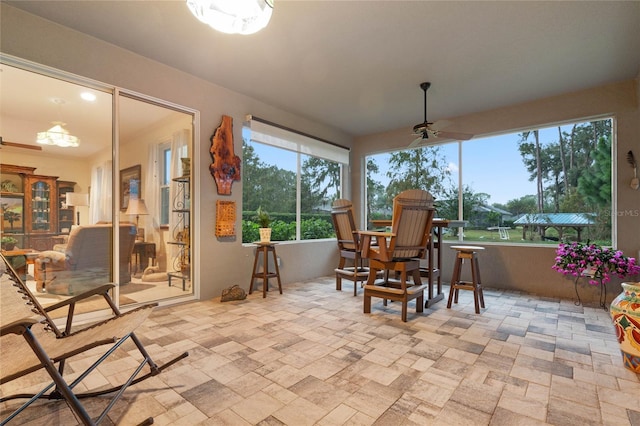 sunroom featuring ceiling fan