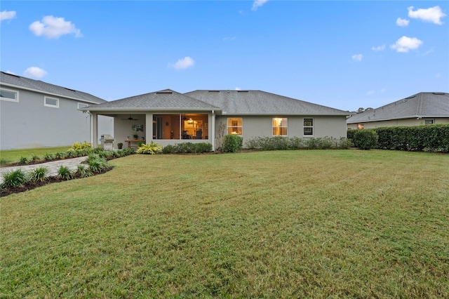 rear view of house with a yard