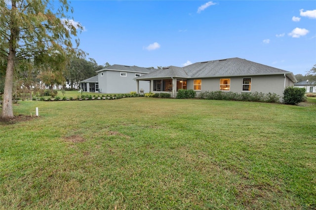 back of house with a lawn