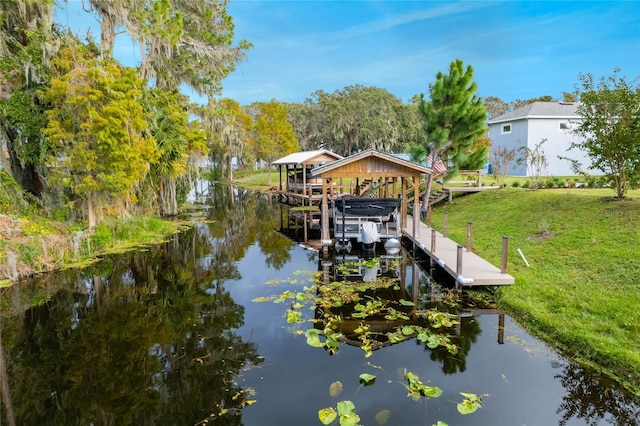 view of dock featuring a water view and a yard