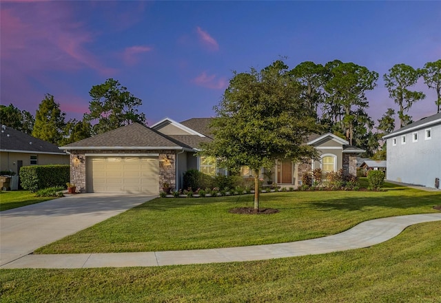 ranch-style home with a garage and a lawn