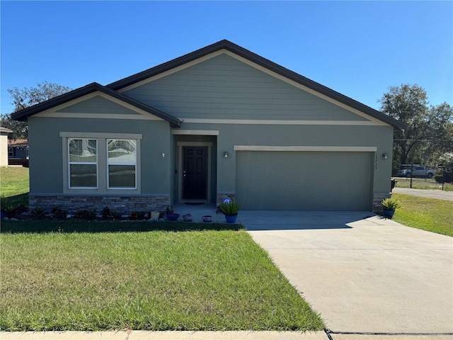 view of front of property with a garage and a front lawn