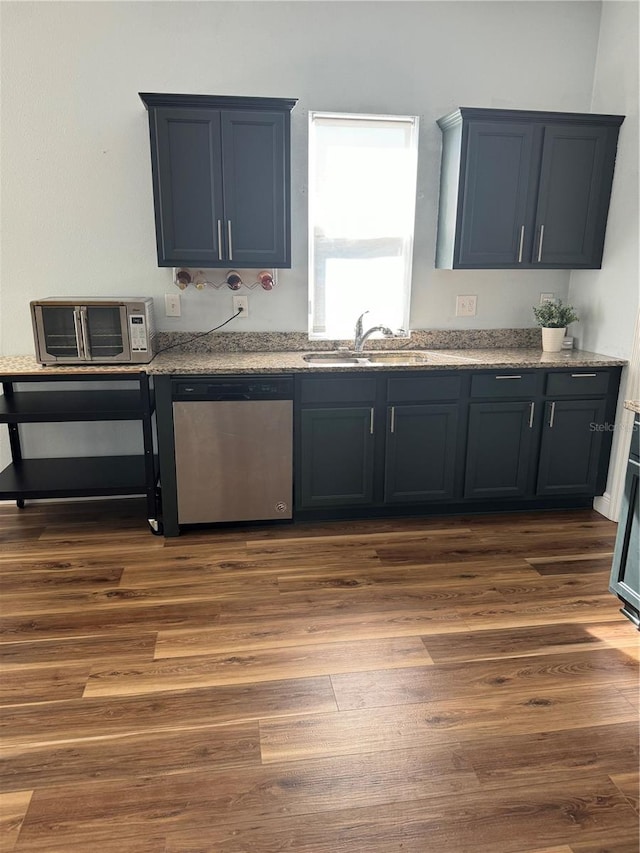 kitchen with sink, stainless steel dishwasher, and dark hardwood / wood-style floors