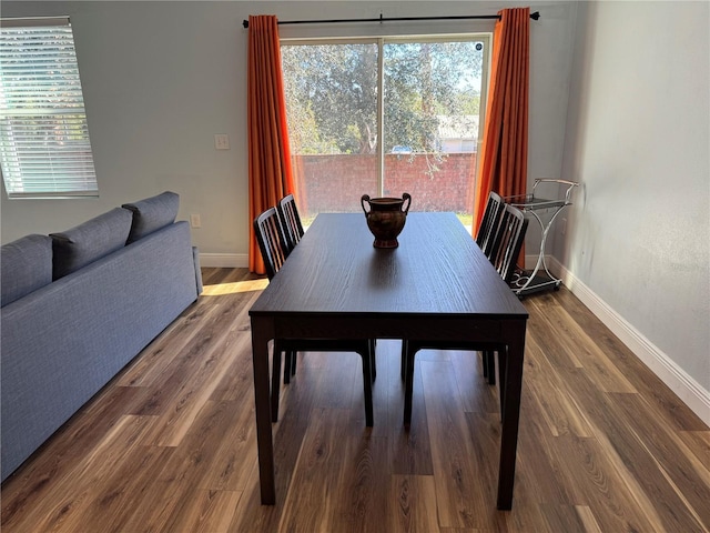 dining room with dark hardwood / wood-style flooring