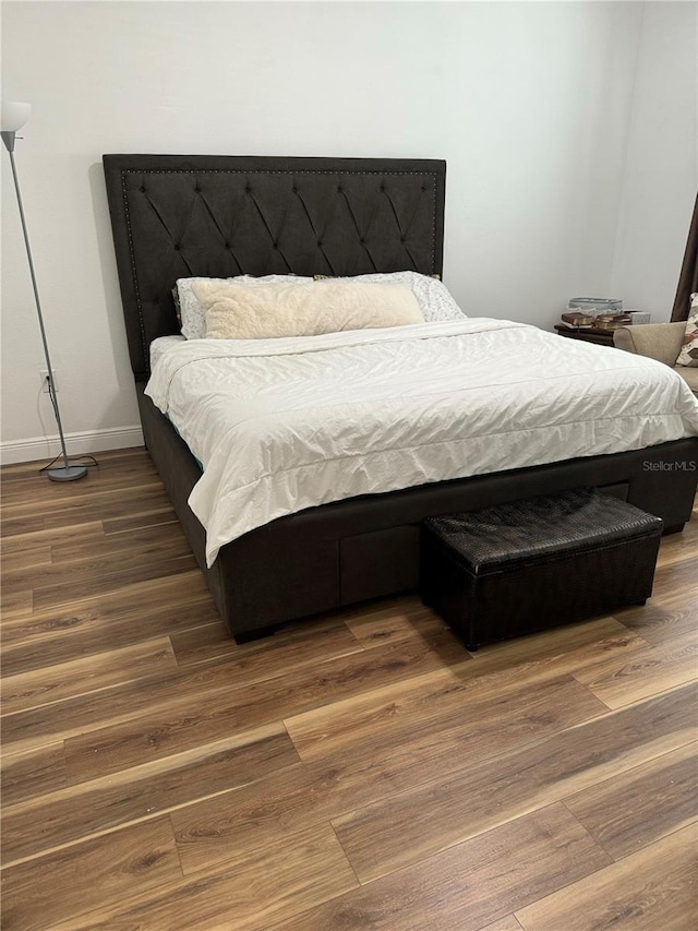 bedroom featuring dark hardwood / wood-style flooring