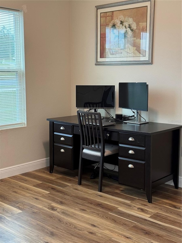 home office with dark hardwood / wood-style flooring