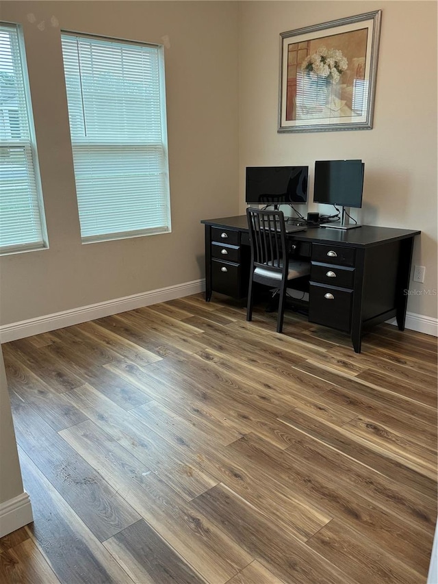 office space with dark wood-type flooring