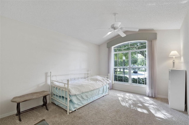 carpeted bedroom featuring a textured ceiling, ceiling fan, and lofted ceiling