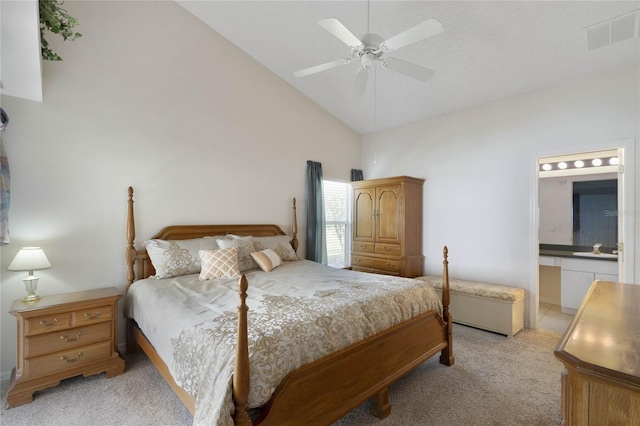 carpeted bedroom featuring ceiling fan, high vaulted ceiling, and ensuite bathroom