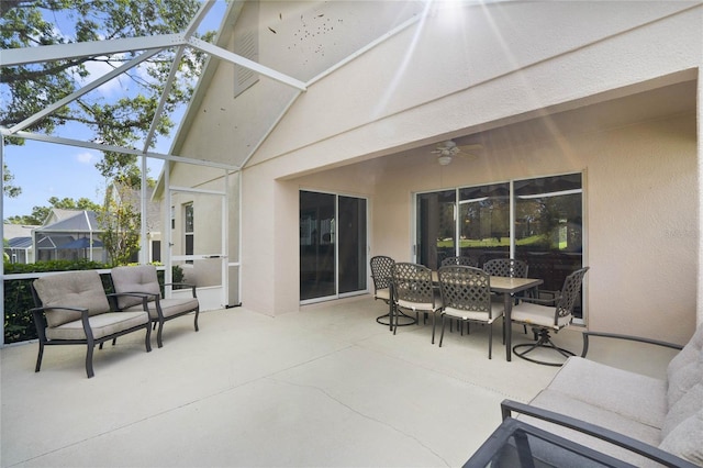 view of patio featuring glass enclosure and ceiling fan