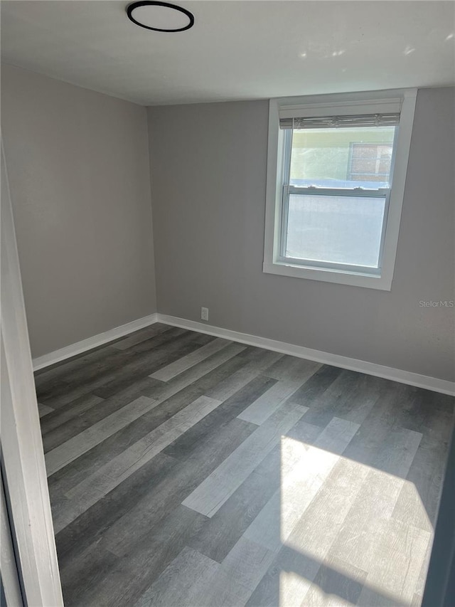 unfurnished room featuring dark hardwood / wood-style flooring