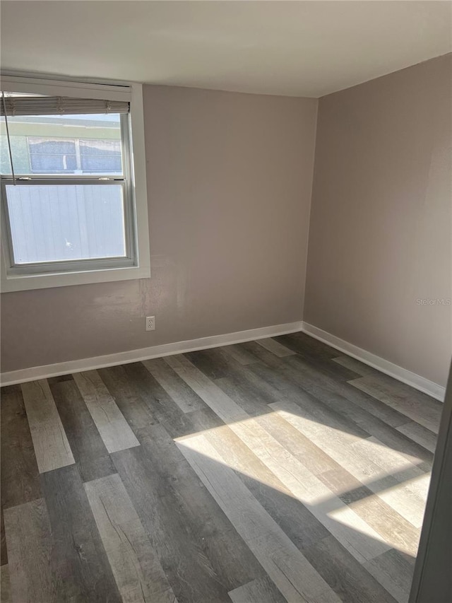 empty room with dark hardwood / wood-style floors