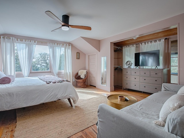 bedroom with a closet, ceiling fan, vaulted ceiling, and light hardwood / wood-style floors