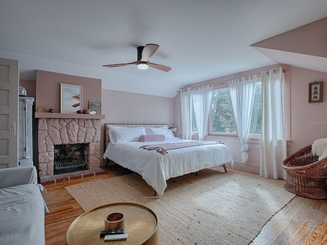 351 W 10th Ave, Mount Dora, FL 32757 - bedroom with wood finished floors, lofted ceiling, a stone fireplace, and a ceiling fan