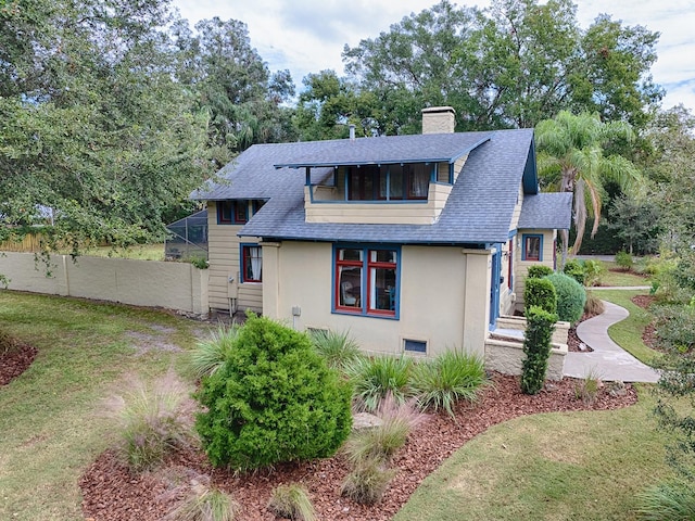 351 W 10th Ave, Mount Dora, FL 32757 - back of house featuring a shingled roof, a chimney, and stucco siding
