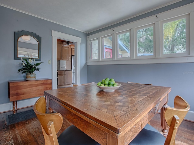 dining room with ornamental molding and dark hardwood / wood-style floors