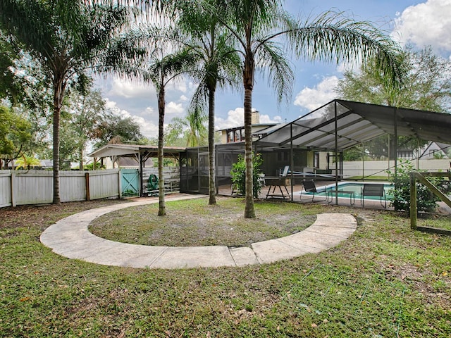 view of yard with a patio, a fenced in pool, and glass enclosure