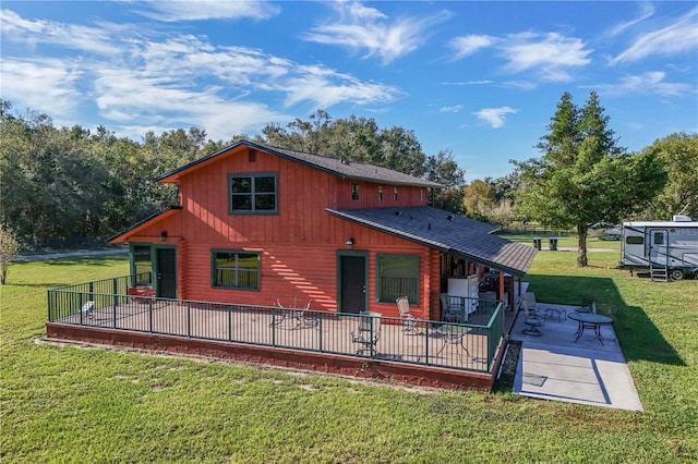 back of house featuring a patio and a yard