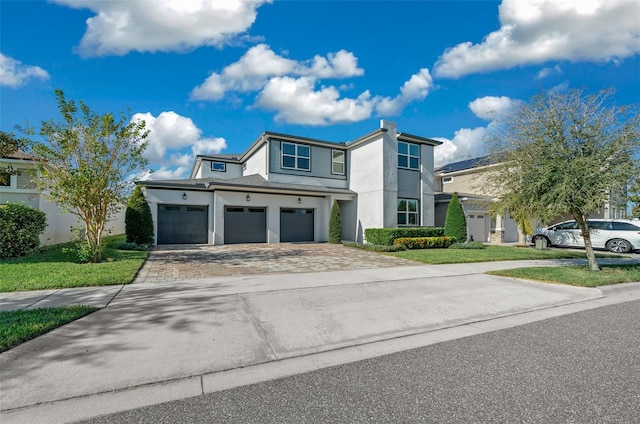 view of front of house with a garage and a front lawn