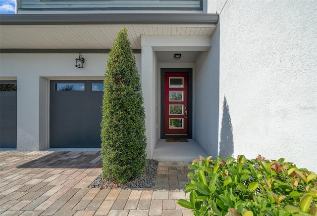 view of exterior entry featuring a garage