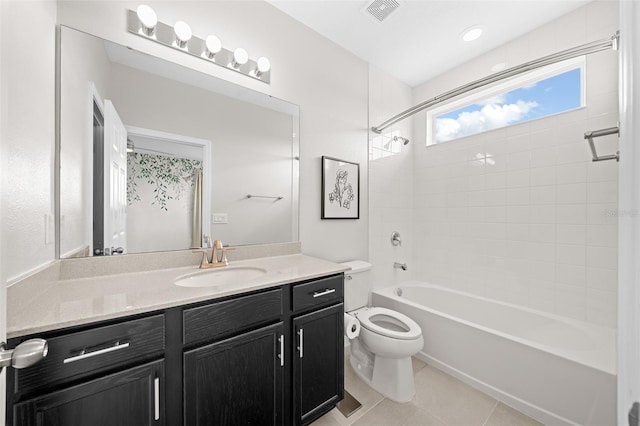 full bathroom with toilet, tile patterned flooring, vanity, and tiled shower / bath